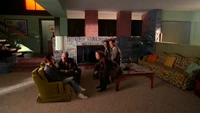 Oliver Martin with a group of investigators, seemingly sitting in the Brady Bunch house