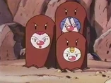 EP135 Team Rocket disfrazado de Dugtrio
