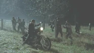 Daryl driveing away from walkers