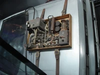 A rack of vacuum tubes and other components strapped to the hood replaces the time control microchip.