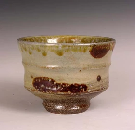 A contemporary salt glazed bowl with iron painted decoration.