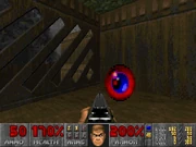 A blur artifact sits in the tower behind the yellow door in E1M3: Toxin Refinery.