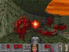 Three enemies being gibbed, plus two gib corpses on the ground, in E4M8: Unto the Cruel