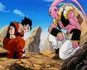 Super Buu looks down at a weary Gohan after his absorption of Gotenks and Piccolo.