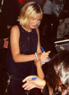 Actress Kirsten Dunst (b. 1982) signs autographs in 2005.