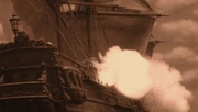 A sailing ship firing