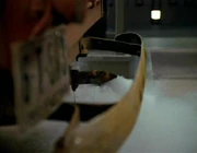 A rusty tailpipe expelling carbon monoxide.