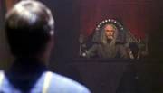 Archer stands before the magistrate.
