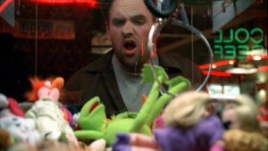 Randy tries to win a Kermit in "Monkeys in Space". Other Muppet dolls shown in the machine include Miss Piggy and Beaker.