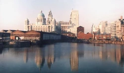Liverpool waterfront. Pier Head, "Three Graces", seen from Albert Dock.  Liverpool, England, United Kingdom.