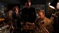 Henry Weems shows one of his many hand-made contraptions to Mulder and Scully